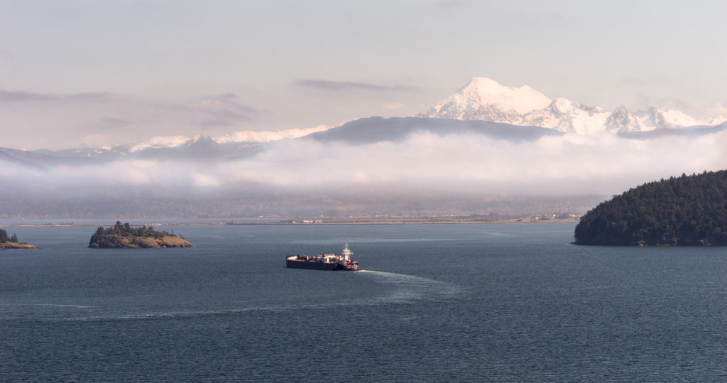 Vessel moving through the Salish Sea with Mount Baker in the background